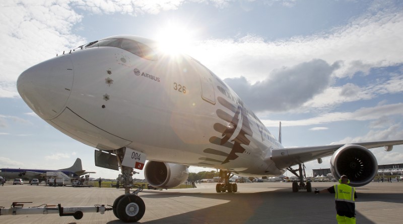 © Reuters. A landing signal officer guides Airbus A350-900 to be parked for upcoming ILA Berlin Air Show in Selchow