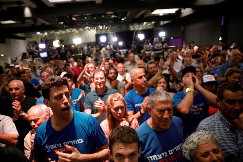 © Reuters. Supporters of Avi Gabbai, the new leader of Israel's centre-left Labour party, react as he delivers a victory speech after winning the Labour party primary runoff, at an event in Tel Aviv