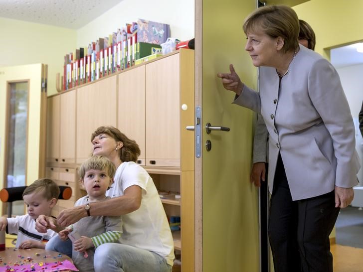 © Reuters. German Chancellor Merkel enters a room at the City Kindergarten in Berlin