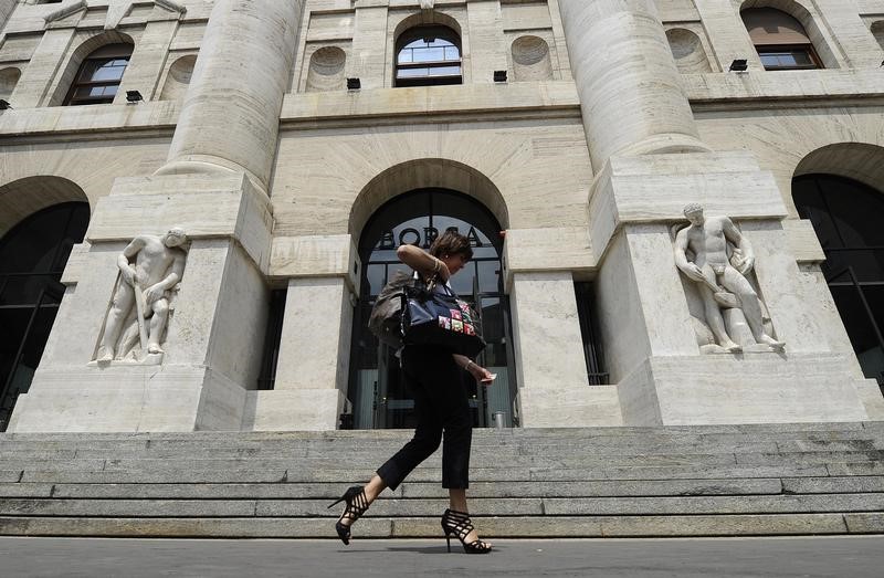 © Reuters. A woman walks past Milan Stock Exchange
