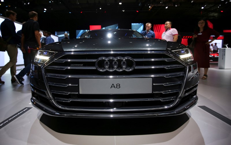 © Reuters. Attendees view the Audi A8 at the Audi Summit in Barcelona