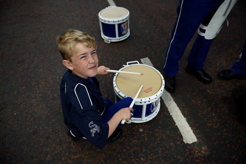 © Reuters. A young drummer with a marching band warms up at the start of the Twelfth of July events held by members of Loyalist Orders in Belfast