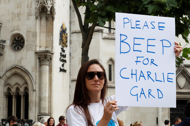 © Reuters. A women campaigns to show support for allowing Charlie Gard to travel to the United Stated to receive further treatment, outside the High Court in London