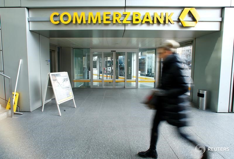 © Reuters. FILE PHOTO: A woman walks past a branch of Commerzbank