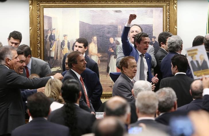© Reuters. Deputados comemoram resultado de votação na CCJ da Câmara contrária à denúncia contra o presidente Michel Temer