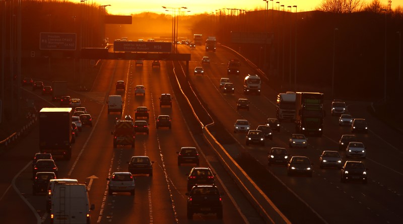 © Reuters. Traffic flows along the M56 motorway as the sun sets near Manchester, northern England