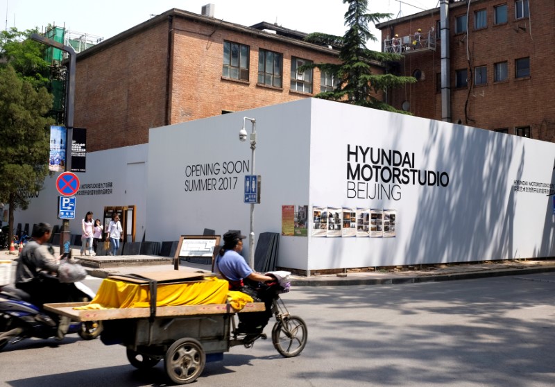 © Reuters. FILE PHOTO: A tricycle drives past the construction site of the Hyundai Motor Studio in Beijing