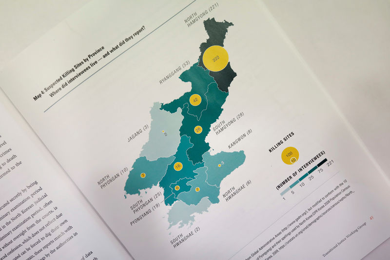 © Reuters. A graphic showing suspected killing sites in North Korea is seen in a report compiled by Transitional Justice Working Group, during an interview in Seoul