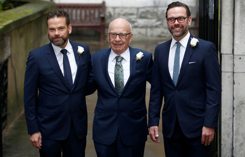 © Reuters. FILE PHOTO: Media Mogul Rupert Murdoch poses for a photograph with his sons Lachlan and James as they arrive at St Bride's church for a service to celebrate the wedding between Murdoch and former supermodel Jerry Hall in London