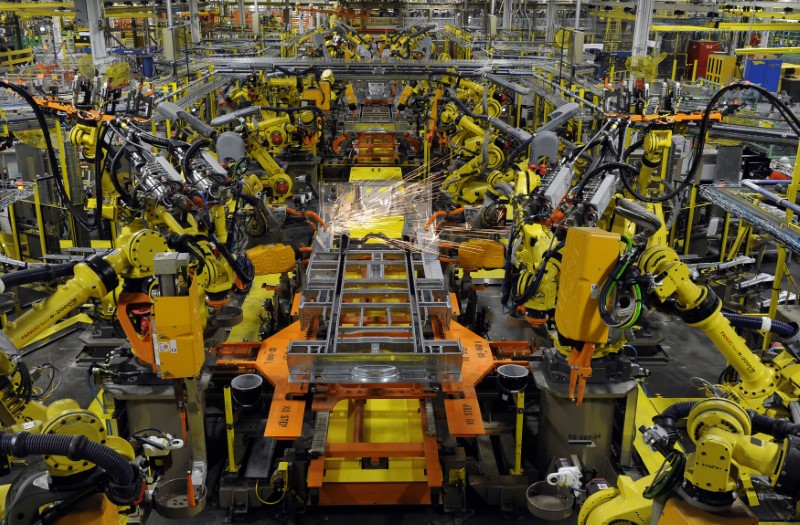 © Reuters. Robotic arms spot welds on the chassis of a Ford Transit Van under assembly at the Ford Claycomo Assembly Plant in Claycomo