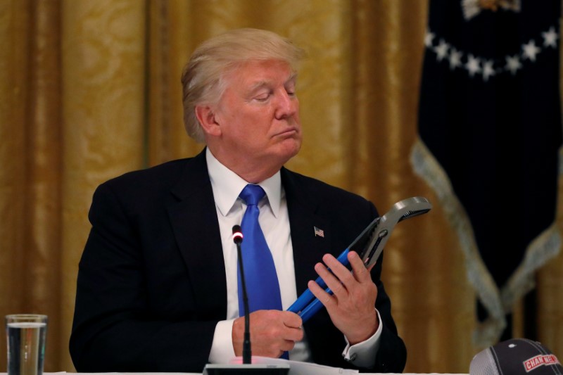 © Reuters. U.S. President Donald Trump holds a mechanical tool as he attends a Made in America roundtable in the East Room of the White House in Washington, U.S.