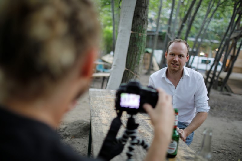 © Reuters. Activist Jonathan Whitlam interviews British citizen Rob, who lives in Fridriechshain district in Berlin