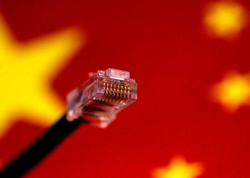 © Reuters. FILE PHOTO: Illustration photo of a computer network cable above a Chinese flag