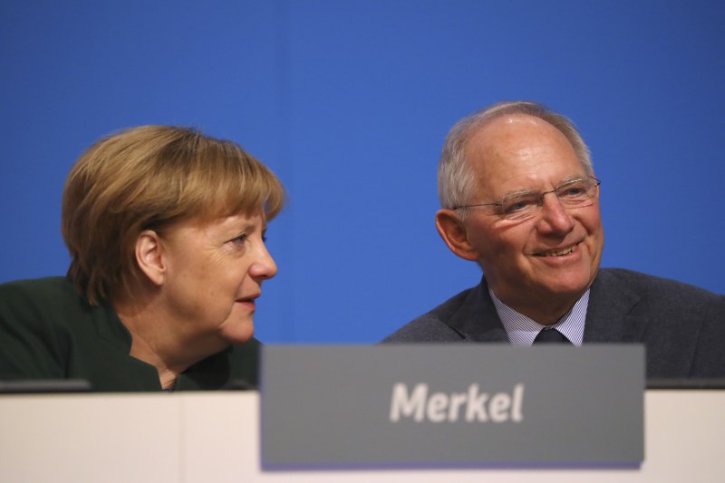 © Reuters. German Chancellor and CDU leader Merkel and Finance Minister Schaeuble attend the CDU party convention in Essen