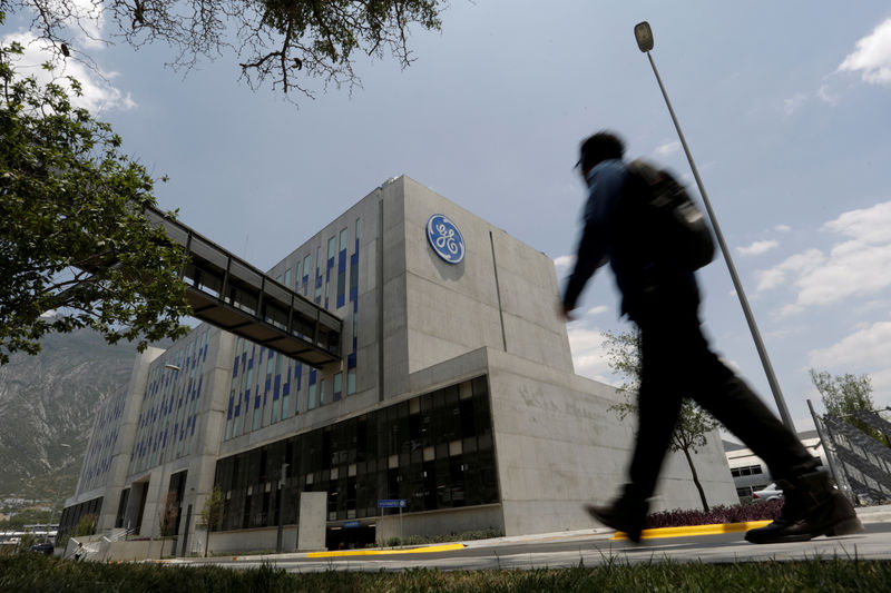 © Reuters. Man walks past the Global Operations Center of General Electric Co. in San Pedro Garza Garcia