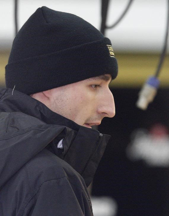 © Reuters. Lotus Renault Formula One driver Kubica looks on before a test session in Valencia
