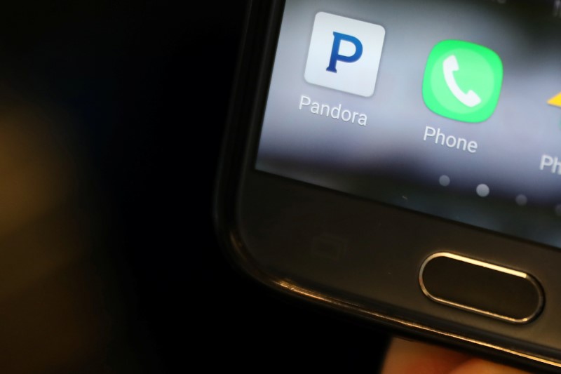 © Reuters. A person holds a smart phone with the Pandora app showing in New York