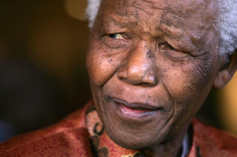 © Reuters. FILE PHOTO: Former President Nelson Mandela smiles as he formally announces his retirement from public life at his foundations offices in Johannesburg