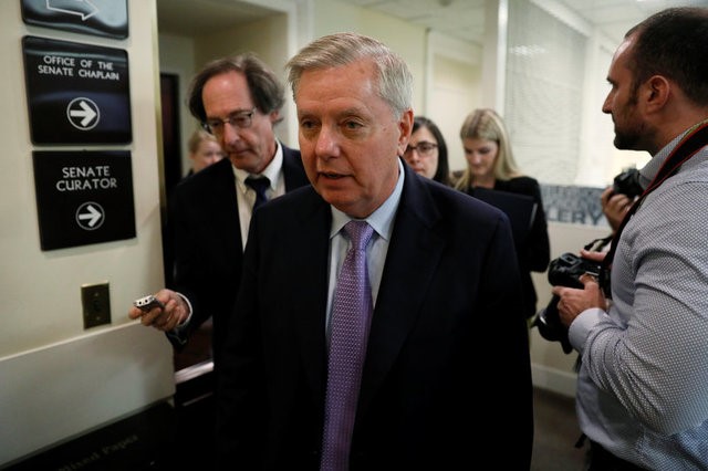 © Reuters. Graham is trailed by reporters after a news conference where he talked about possible legislation for so-called "dreamer" immigrant children as well as the health of McCain at the U.S. Capitol in Washington