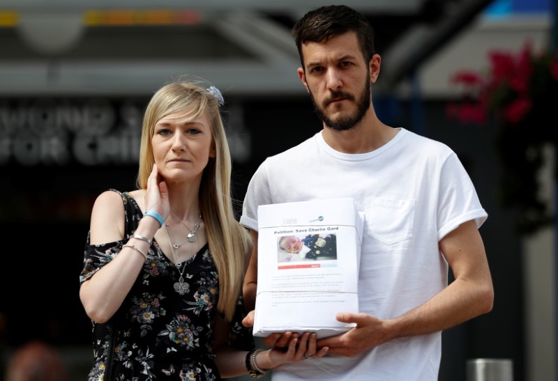 © Reuters. Pais de Charlie Gard, um bebê britânico que sofre com uma doença terminal, posam na frente do hospital Great Ormond Street, em Londres