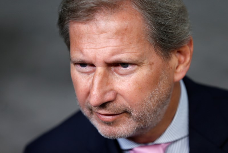 © Reuters. EU Commissioner Hahn talks to the media ahead of an EU foreign ministers' meeting in Brussels