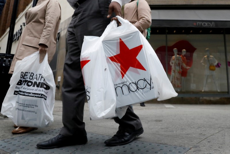 © Reuters. FILE PHOTO: A customer exits after shopping at a Macy's store in the Brooklyn borough of New York