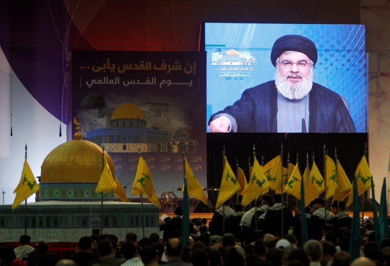 © Reuters. FILE PHOTO: Lebanon's Hezbollah leader Sayyed Hassan Nasrallah addresses his supporters via a screen during a rally marking Al-Quds day in Beirut's southern suburbs