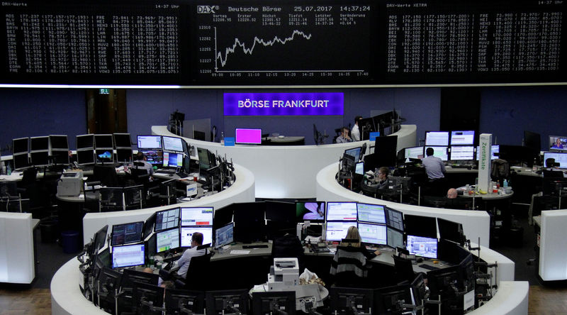 © Reuters. Traders work in front of the German share price index, DAX board, at the stock exchange in Frankfurt