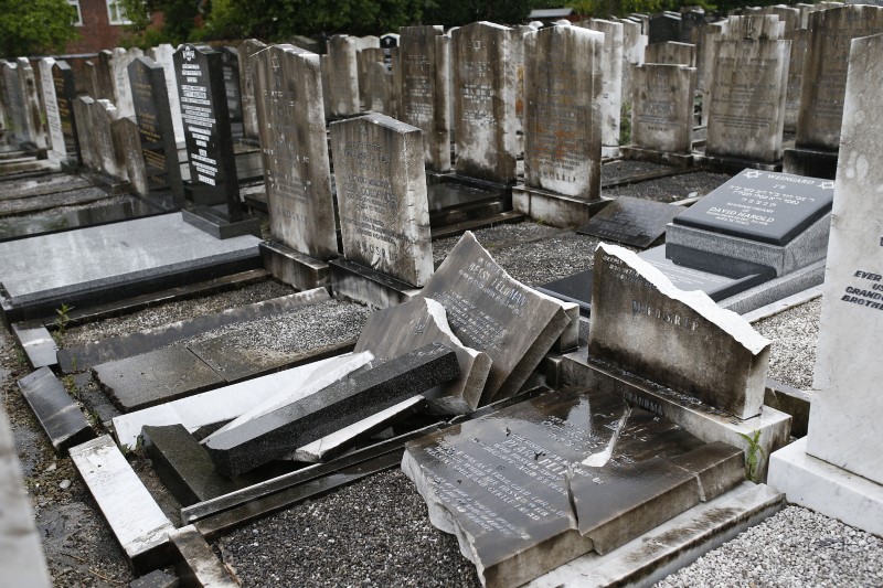 © Reuters. Vandalised headstones are seen at a Jewish cemetery in Blackley