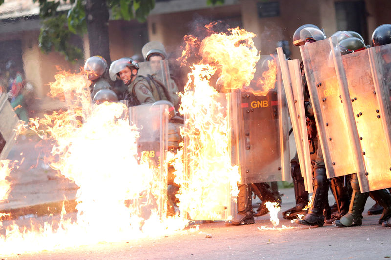 © Reuters. Forças de segurança venezuelanas pegam fogo durante protesto contra o presidente Nicolás Maduro, em Caracas