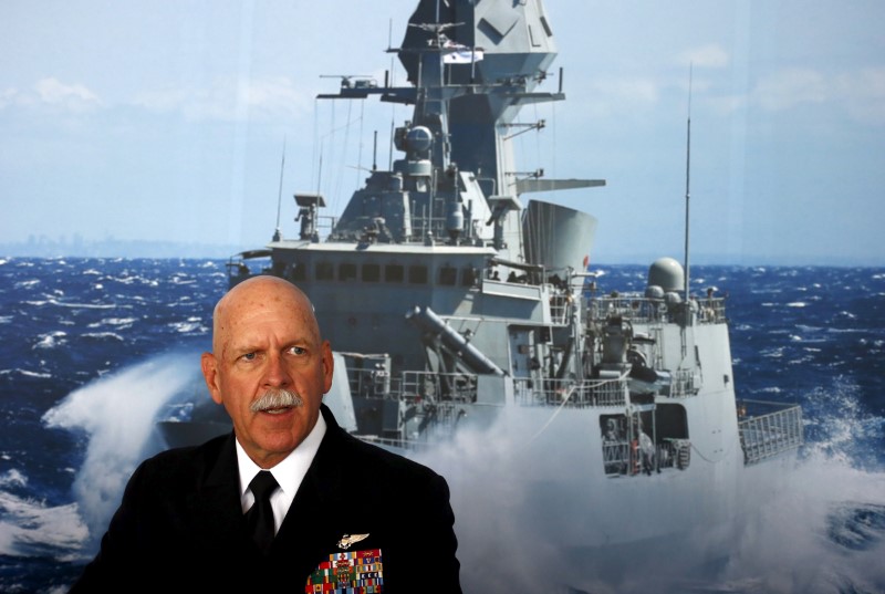 © Reuters. FILE PHOTO: Commander of the US Pacific Fleet Admiral Scott Swift sits in front of a large poster of an Australian Navy Australia