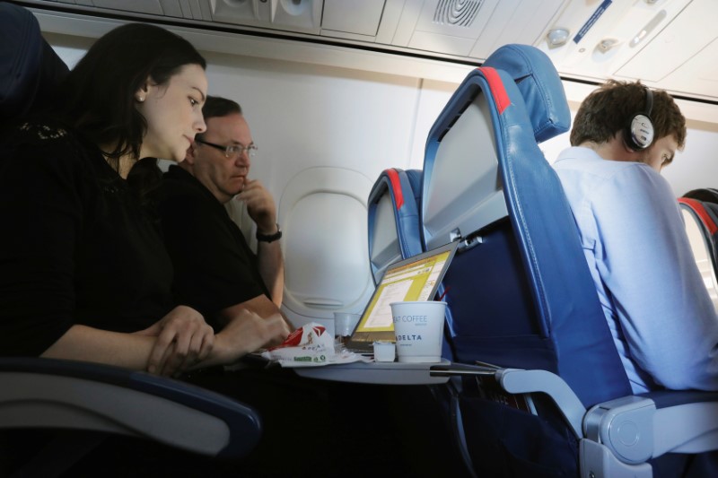 © Reuters. A woman uses her laptop on a flight out of JFK International Airport in New York