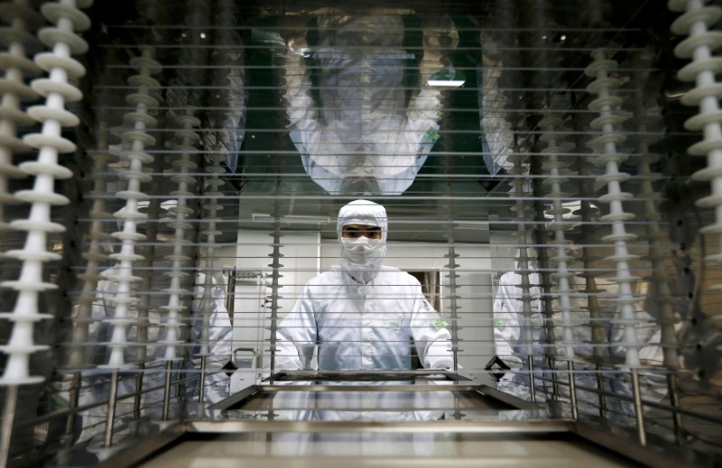© Reuters. FILE PHOTO: An employee works inside an electronic products factory in Huzhou