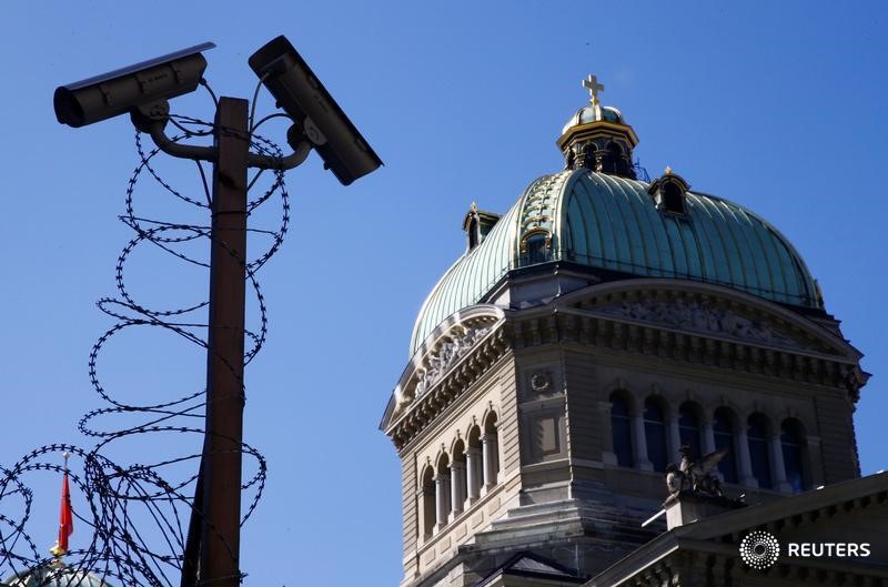 © Reuters. CCTV cameras checking the outside of the Swiss National Bank are pictured in front of the Federal Palace in Bern