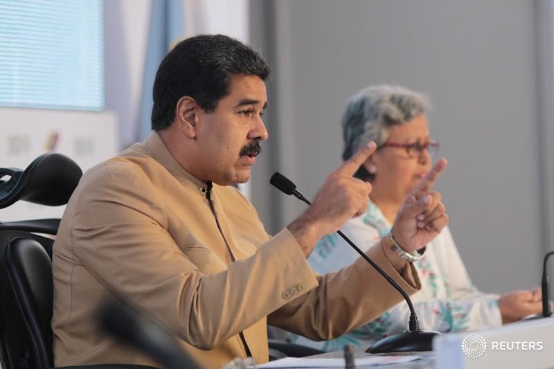 © Reuters. Venezuela's President Nicolas Maduro speaks next to National Electoral Council (CNE) President Tibisay Lucena during their meeting in Caracas