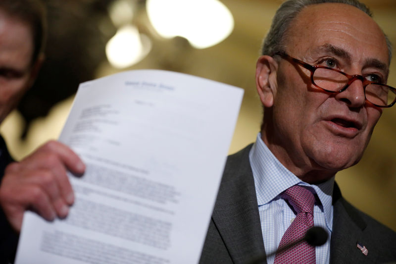 © Reuters. Senate Minority Leader Chuck Schumer holds up a letter about tax policy sent by Democrats to the Republican leadership as he speaks with reporters following the party luncheons on Capitol Hill in Washington