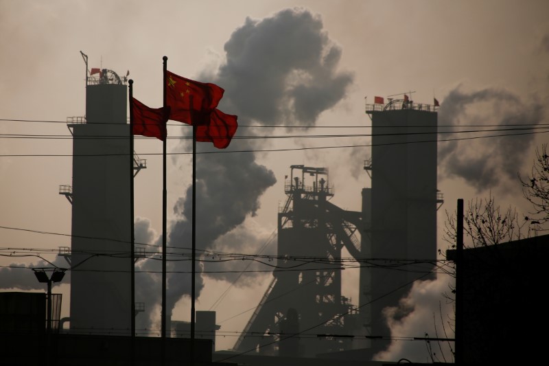 © Reuters. Chinese national flags are flying near a steel factory in Wu'an
