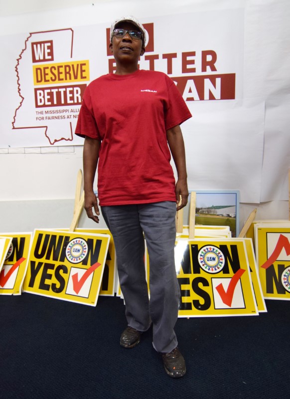 © Reuters. Pro-union Nissan worker Patricia Ruffin shows off signs at the center the United Auto Workers has set up in its efforts to unionize Canton