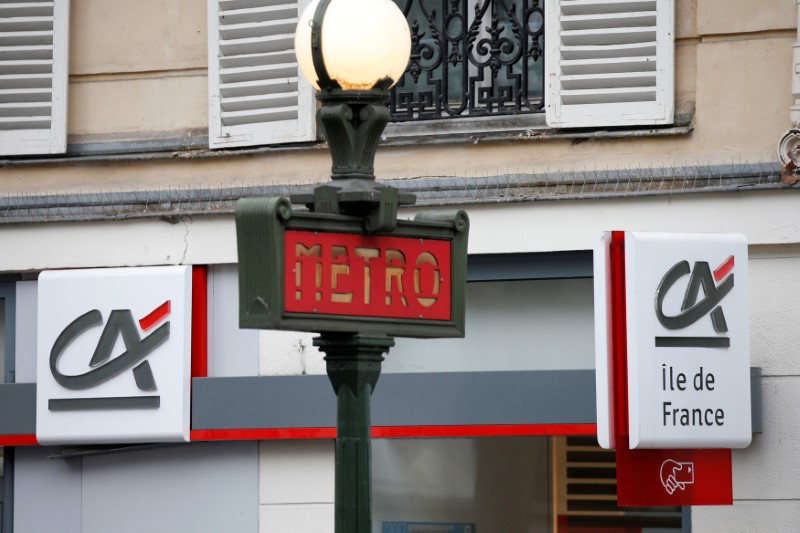 © Reuters. FILE PHOTO: Logos are pictured on a Credit Agricole bank branch in Paris