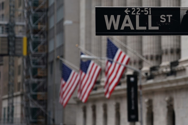 © Reuters. The Wall St sign is picture in front of the New York Stock Exchange (NYSE) in New York City