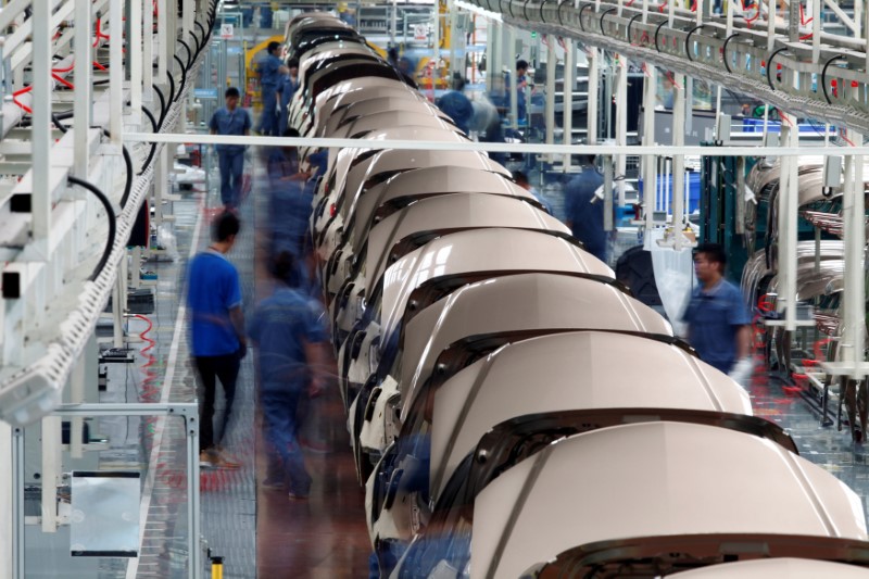 © Reuters. FILE PHOTO: Employees work along a Geely Automobile Corporation assembly line in Cixi