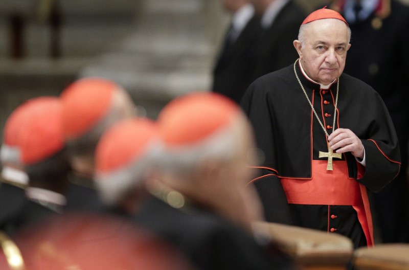 © Reuters. Italian Cardinal Tettamanzi arrives to attend a prayer at Saint Peter's Basilica in the Vatican