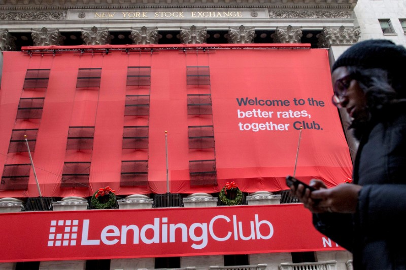 © Reuters. FILE PHOTO: File photo of a woman passing by a Lending Club banner on the facade of the the New York Stock Exchange