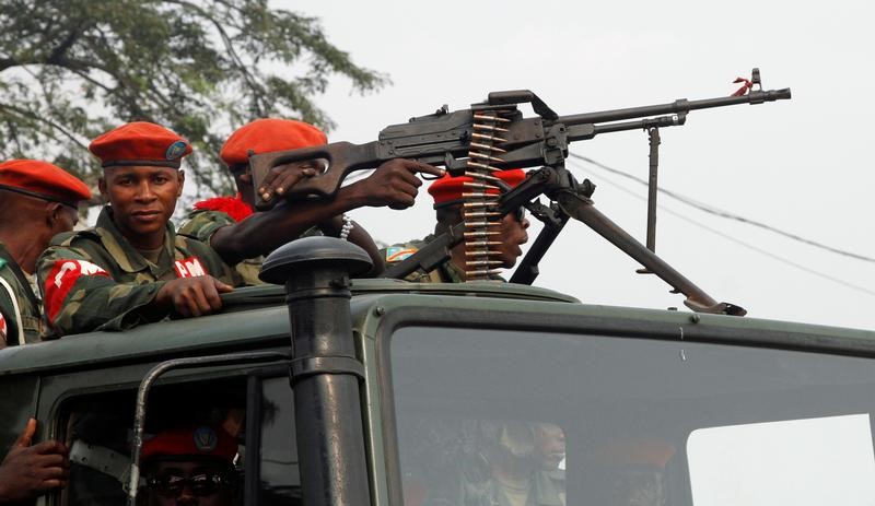 © Reuters. FILE PHOTO: Military police officers ride on a truck as they patrol the streets of Kinshasa