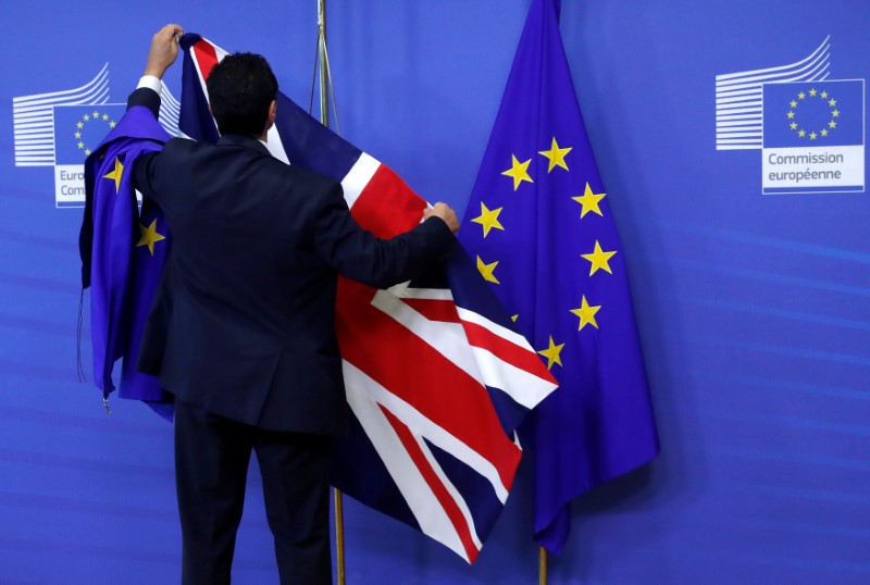 © Reuters. A European Union flag is waved in front of Big Ben outside Parliament after Britain's Prime Minister Theresa May triggered the process by which the United Kingdom will leave the European Union in London