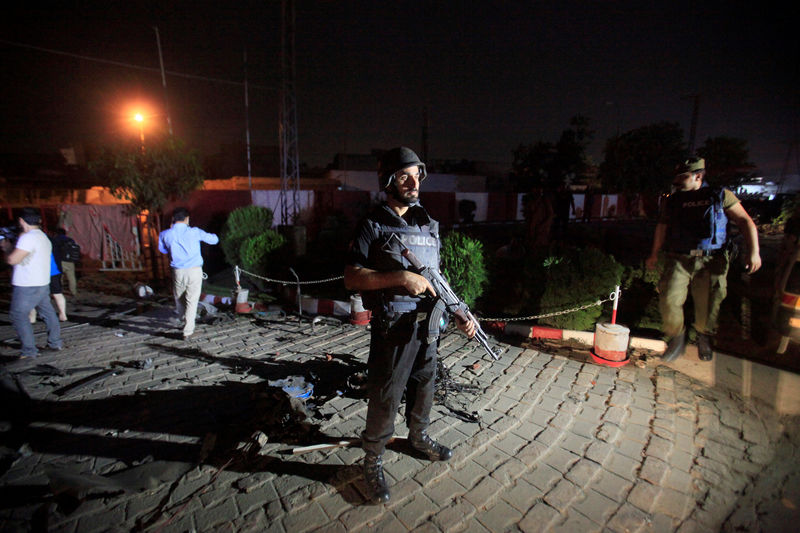 © Reuters. A policeman stands guard after a blast in Lahore