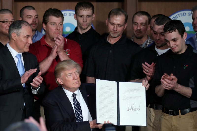 © Reuters. FILE PHOTO: U.S. President Donald Trump holds up an executive order on "Energy Independence," eliminating Obama-era climate change regulations, during a signing ceremony at the Environmental Protection Agency (EPA) headquarters in Washington, U.