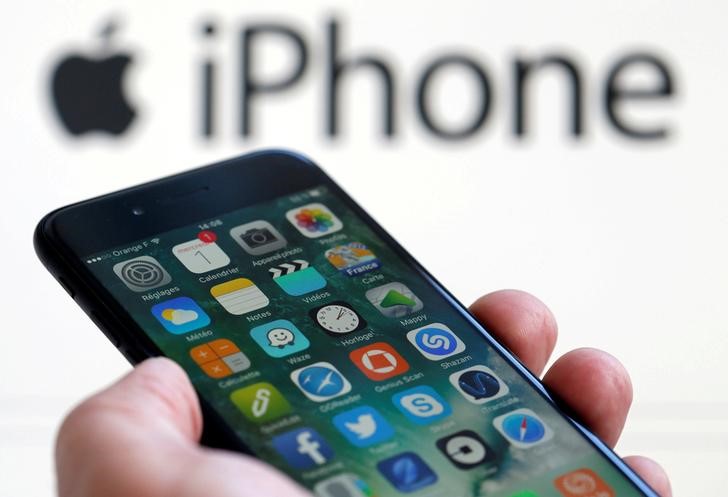 © Reuters. iPhone 7 diante de projeção do logo da Apple