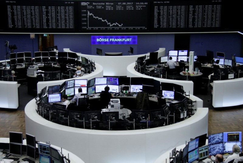 © Reuters. Traders work in front of the German share price index, DAX board, at the stock exchange in Frankfurt