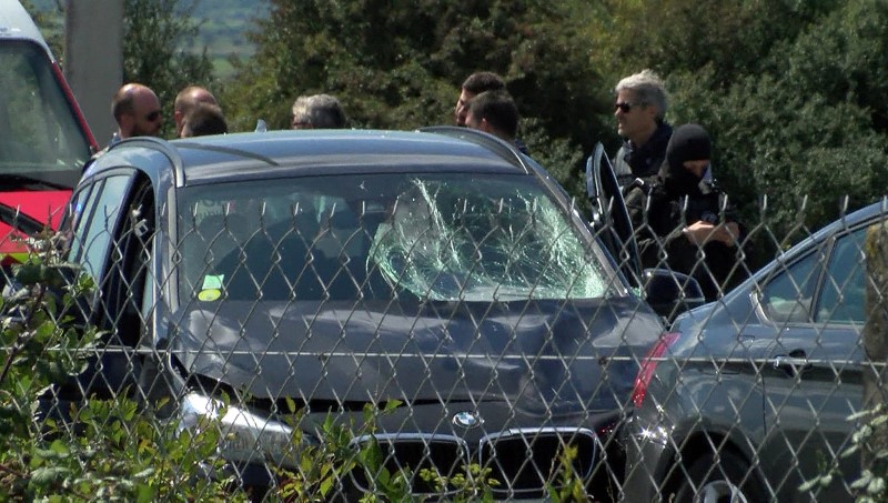 © Reuters. A still image taken from a video shows French police who surround a BMW car with several bullet impacts at the scene where the man suspected of ramming a car into a group of soldiers in a Paris suburb, was shot and arrested on the A16 motorway, near Marqui